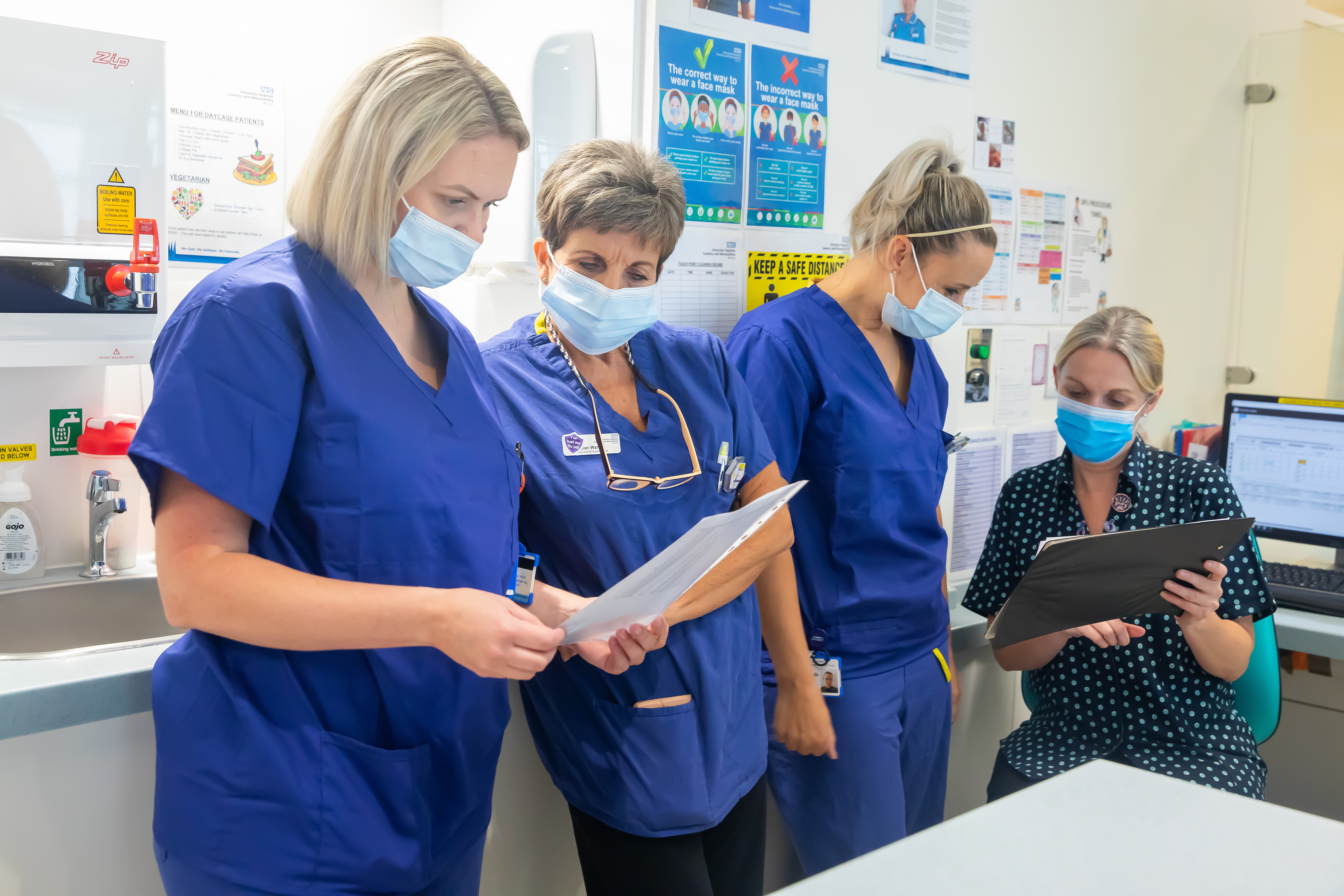 Nursing staff reading documents and clipboard
